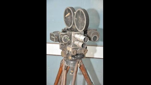 In the office, among other antique equipment, an old cine camera is kept, and a modern computer, mostly used to watch films, appears strangely out of place here. (Samir Jana / HT Photo) 