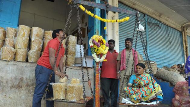 A devotee (R) sits on a scale to buy jaggery in a quantity equal to her weight from a wholesale shop in Hyderabad. Devotees of tribal deities "Samakka-Saralakka" offer jaggery equal to their weight to fulfil vows, during 'Medaram Jatara' festival which is held bi-annually in Telangana. (Noah Seelam / AFP) A devotee (R) sits on a scale to buy jaggery in a quantity equal to her weight from a wholesale shop in Hyderabad. Devotees of tribal deities "Samakka-Saralakka" offer jaggery equal to their weight to fulfil vows, during 'Medaram Jatara' festival which is held bi-annually in Telangana. (Noah Seelam / AFP)