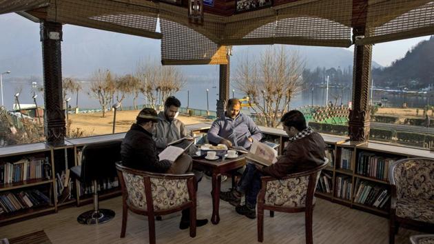 Readers flip through their books with the scenic Dal Lake in the backdrop at Nehru Park in Srinagar. Gulshan Books Kashmir, a bookstore with its collection of 80,000 titles, was recently included in the 2018 Limca Book of Records for being the only library in the country set on a lake. (S Irfan / PTI) Readers flip through their books with the scenic Dal Lake in the backdrop at Nehru Park in Srinagar. Gulshan Books Kashmir, a bookstore with its collection of 80,000 titles, was recently included in the 2018 Limca Book of Records for being the only library in the country set on a lake. (S Irfan / PTI)