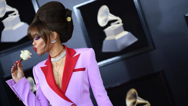 Overall, the usual wacky carpet at the Grammys was more subdued than in years past. There was plenty of black, both traditional tuxedos and dresses and more edgy outfits. But there was also lots of color; Andra Day did it beautifully in bright pink for a long dress with red trim, tuxedo lapels and pocket details. Her hair was piled high in a beehive. (jewel Samad / AFP) Overall, the usual wacky carpet at the Grammys was more subdued than in years past. There was plenty of black, both traditional tuxedos and dresses and more edgy outfits. But there was also lots of color; Andra Day did it beautifully in bright pink for a long dress with red trim, tuxedo lapels and pocket details. Her hair was piled high in a beehive. (jewel Samad / AFP)