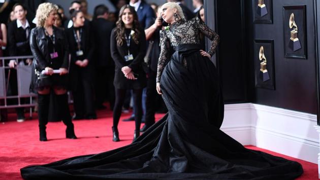 Lady Gaga arrived in a lace cat suit with a statement skirt by Armani Prive. Her long platinum hair was swept back in a fishtail braid. The look earned her praise all around on a carpet that wasn’t quite as star-studded as usual. (Jewel Samad / AFP) Lady Gaga arrived in a lace cat suit with a statement skirt by Armani Prive. Her long platinum hair was swept back in a fishtail braid. The look earned her praise all around on a carpet that wasn’t quite as star-studded as usual. (Jewel Samad / AFP)
