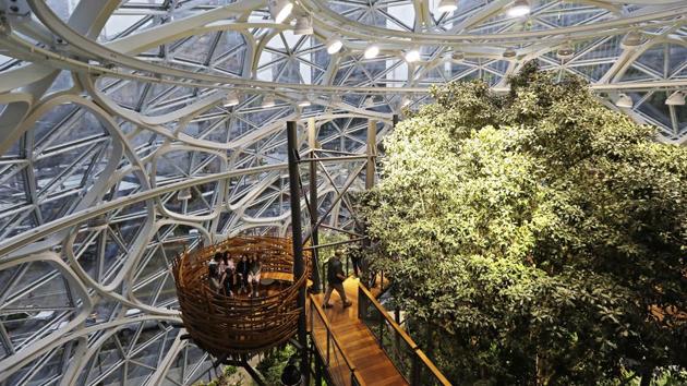 Guests sit in an area of the Amazon Spheres known as “the nest”. The corporate office space, however selfie-worthy, is already such a hit that the company had to create a reservation system to contain the flow of traffic. Employees will have to snag a reservation to get in and it’s already booked out until April. (Ted S. Warren / AP) Guests sit in an area of the Amazon Spheres known as “the nest”. The corporate office space, however selfie-worthy, is already such a hit that the company had to create a reservation system to contain the flow of traffic. Employees will have to snag a reservation to get in and it’s already booked out until April. (Ted S. Warren / AP)