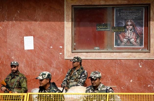 Security personnel stand guard outside a theatre after the release of Hindi film Padmaavat in New Delhi. (REUTERS) Security personnel stand guard outside a theatre after the release of Hindi film Padmaavat in New Delhi. (REUTERS)