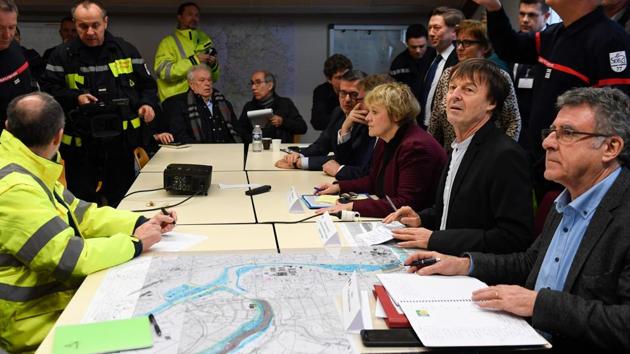 French Minister for the Ecological and Inclusive Transition, Nicolas Hulot (2R) and mayor of Champagne-sur-Seine, Michel Gonord (R) take part in a meeting at the fire station of Champagne-sur-Seine, Paris during an assessment visit on the Seine’s rise. (Eric Feferberg / AFP)