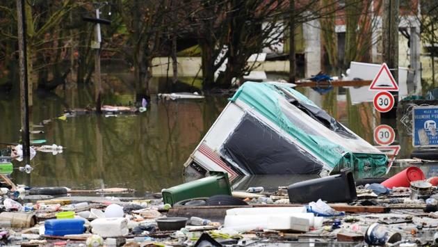Garbage floats in a flooded street of Villeneuve-le-Roi. Till now the floods have caused damage to 242 towns along the river and tributaries with more warnings in place as high waters move downstream. (Alain Jocard / AFP)
