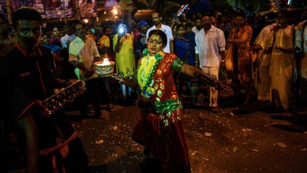 An Ethnic-Malaysian Hindu devotee (C) dances as she makes her way towards the Batu caves temple. (Manan Vatsyayana / AFP) An Ethnic-Malaysian Hindu devotee (C) dances as she makes her way towards the Batu caves temple. (Manan Vatsyayana / AFP)