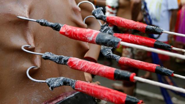 A devotee with hooks pierced into his back participates in the Thaipusam procession in Kuala Lumpur. (Lai Seng Sin / REUTERS) A devotee with hooks pierced into his back participates in the Thaipusam procession in Kuala Lumpur. (Lai Seng Sin / REUTERS)