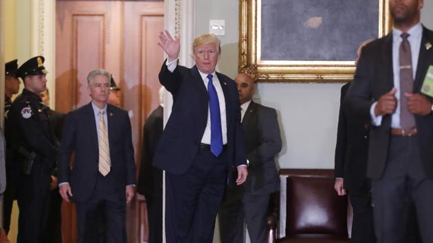 US President Donald Trump waves as he departs after lobbying Republicans at their weekly policy luncheon on Capitol Hill in Washington. (REUTERS) US President Donald Trump waves as he departs after lobbying Republicans at their weekly policy luncheon on Capitol Hill in Washington. (REUTERS)
