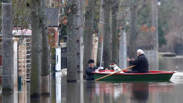 Residents on a small boat evacuate their house in a flooded street of Villeneuve-Saint-Georges, near Paris. The Meteo France weather service said January has seen nearly double the normal rainfall nationwide, and the rains in the past two months are the highest measured for the period in 50 years. (Christian Hartmann / REUTERS)