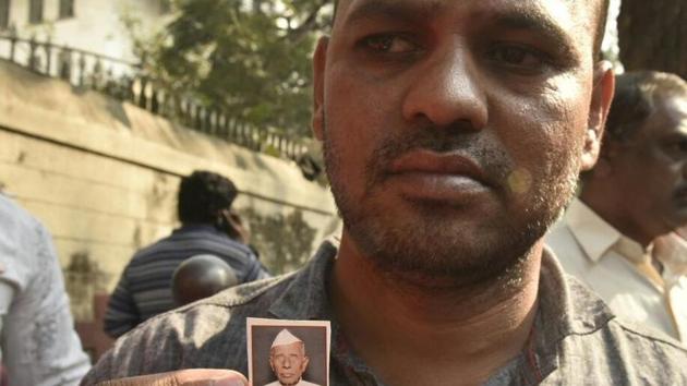 Dharma Patil’s son shows his picture. (FILE) Dharma Patil’s son shows his picture. (FILE)