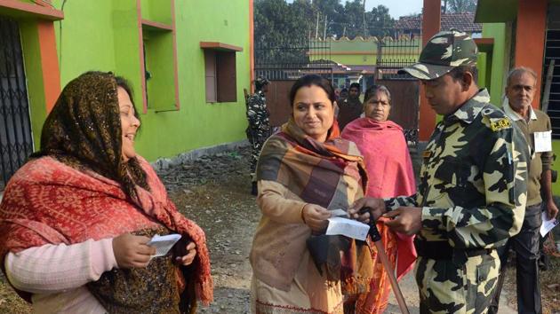A security personnel checks a voter's card during voting for Noapara assembly bypolls in Barrackpore, on the outskirts of Kolkata. (PTI) A security personnel checks a voter's card during voting for Noapara assembly bypolls in Barrackpore, on the outskirts of Kolkata. (PTI)