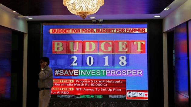 A man speaks on his mobile phone next to a screen telecasting India's budget, inside the Bombay Stock Exchange building in Mumbai, India, February 1, 2018. (REUTERS) A man speaks on his mobile phone next to a screen telecasting India's budget, inside the Bombay Stock Exchange building in Mumbai, India, February 1, 2018. (REUTERS)