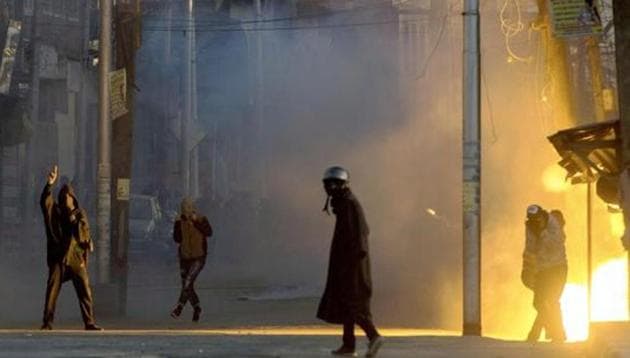 A teargas shell explodes near the protesters who were clashing with security forces following a protest against the alleged killing of two youth Army firing in Shopian district of South Kashmir, in Srinagar on Sunday.
