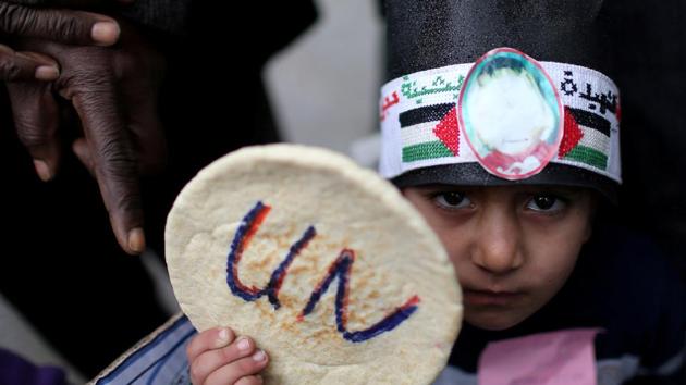 A Palestinian child holds bread during a protest against aid cuts, outside the United Nations' offices in Khan Younis in the southern Gaza Strip on January 28, 2018. (Ibraheem Abu Mustafa / REUTERS) A Palestinian child holds bread during a protest against aid cuts, outside the United Nations' offices in Khan Younis in the southern Gaza Strip on January 28, 2018. (Ibraheem Abu Mustafa / REUTERS)