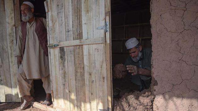 An Afghan refugee man makes a mud building at a refugee camp on the outskirts of Islamabad on February 1, 2018. (AFP Photo) An Afghan refugee man makes a mud building at a refugee camp on the outskirts of Islamabad on February 1, 2018. (AFP Photo)
