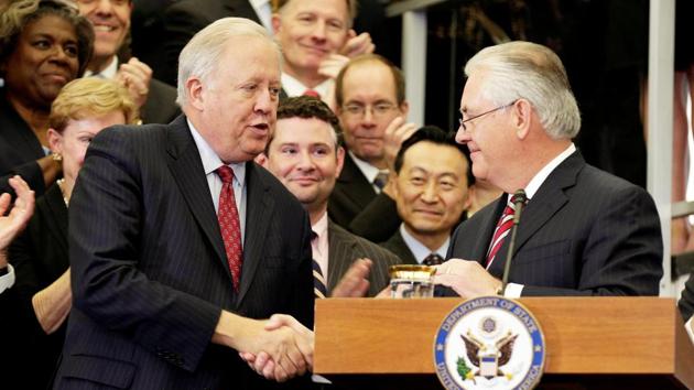 US secretary of state Rex Tillerson shakes hands with Tom Shannon while delivering remarks to Department of State employees in Washington.(Reuters File Photo)