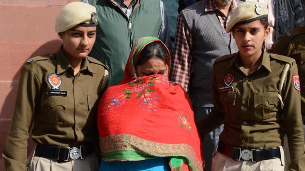 Accused Sweety being taken away after the recovery of gold and opium from her locker at the State Bank of India branch in SA Jain College in Ambala on Friday. (HT Photo) Accused Sweety being taken away after the recovery of gold and opium from her locker at the State Bank of India branch in SA Jain College in Ambala on Friday. (HT Photo)
