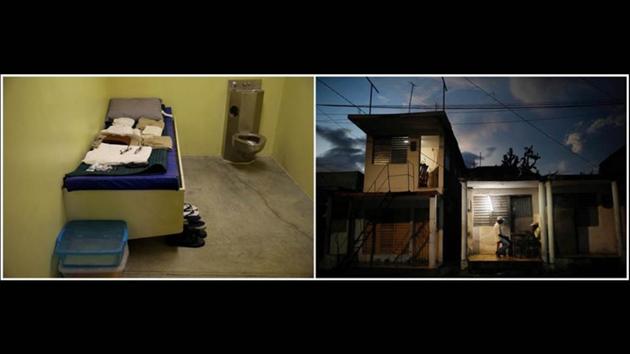 An austere, windowless cell for detainees at the base (L) contrasts with locals playing dominoes outside their homes at dusk. (Carlos Barria / REUTERS) An austere, windowless cell for detainees at the base (L) contrasts with locals playing dominoes outside their homes at dusk. (Carlos Barria / REUTERS)