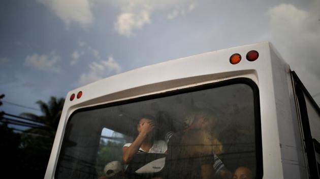 Local residents ride on a bus in the city of Guantanamo, Cuba. Guantanamo the US naval base in Cuba is more than a century old, but the Cuban government had considered it illegal under the international law. This week, US President has ordered that the center remains open. Guantanamos the city and the naval base capture the stark contrasts with hardly any communication between them. (Carlos Barria / REUTERS) Local residents ride on a bus in the city of Guantanamo, Cuba. Guantanamo the US naval base in Cuba is more than a century old, but the Cuban government had considered it illegal under the international law. This week, US President has ordered that the center remains open. Guantanamos the city and the naval base capture the stark contrasts with hardly any communication between them. (Carlos Barria / REUTERS)
