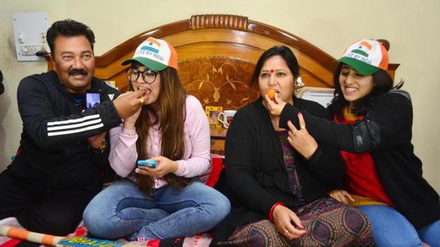 Abhishek Sharma’s parents Raj Kumar Sharma and Manju Sharma and sisters Komal Sharma (2nd from left) and Saniya Sharma (right) offering sweets to each other at their house in Amritsar on Saturday. (Sameer Sehgal/HT) Abhishek Sharma’s parents Raj Kumar Sharma and Manju Sharma and sisters Komal Sharma (2nd from left) and Saniya Sharma (right) offering sweets to each other at their house in Amritsar on Saturday. (Sameer Sehgal/HT)