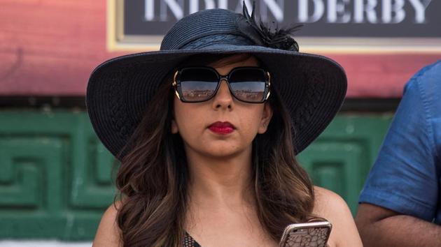 Women spectators commonly sport dramatic hats with wide brims, ornamentations and bold hues. (Pratik Chorge / HT Photo)