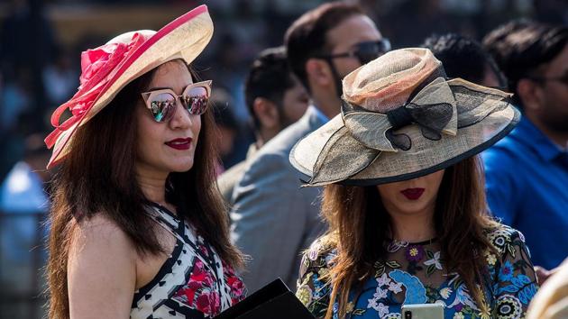 Spectators don hats decorated with bright-textured ribbons and bows. (Pratik Chorge / HT Photo)