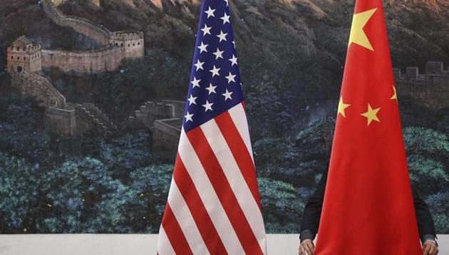 A Chinese man adjusts a China flag before a news conference attended at the Great Hall of the People in Beijing September 5, 2012.(Reuters File Photo)