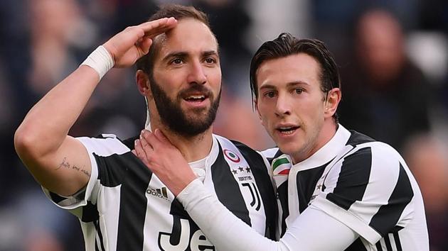 Juventus' Argentinian forward Gonzalo Higuain (L) celebrates with teammate Federico Bernardeschi (R) after scoring against Sassuolo in their Serie A football match on at the 'Allianz Stadium' in Turin on Sunday. (AFP) Juventus' Argentinian forward Gonzalo Higuain (L) celebrates with teammate Federico Bernardeschi (R) after scoring against Sassuolo in their Serie A football match on at the 'Allianz Stadium' in Turin on Sunday. (AFP)