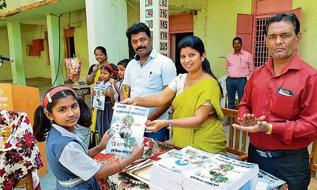 Representatives from the zilla parishad distributing the book based on a monthly syllabus to students. (HT PHOTO) Representatives from the zilla parishad distributing the book based on a monthly syllabus to students. (HT PHOTO)