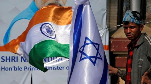 A man holds flags of India and Israel before installing them on a lamp post ahead of the visit of Israeli Prime Minister Benjamin Netanyahu in Ahmedabad on January 15, 2018.(Reuters File) A man holds flags of India and Israel before installing them on a lamp post ahead of the visit of Israeli Prime Minister Benjamin Netanyahu in Ahmedabad on January 15, 2018.(Reuters File)