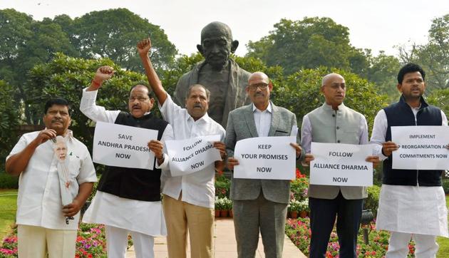Telugu Desam Party (TDP) MPs display placards and raise slogans to ‘save Andhra Pradesh' while staging a protest in front of Gandhi Statue in Parliament House in New Delhi on Monday.(PTI)