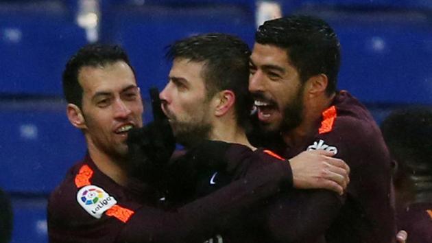 Barcelona’s Gerard Pique celebrates (C) with Sergio Busquets (L) and Luis Suarez (R) after scoring the equaliser against Espanyol in the La Liga on Sunday. (REUTERS) Barcelona’s Gerard Pique celebrates (C) with Sergio Busquets (L) and Luis Suarez (R) after scoring the equaliser against Espanyol in the La Liga on Sunday. (REUTERS)