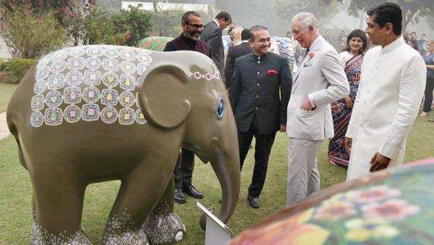 Nirav Modi (C), founder and creative director of luxury diamond jewellery brand, NIRAV MODI, shows to Britain's Prince Charles a diamond-studded elephant sculpture during an Elephant Family charity event at the British High Commissioner's residence, in New Delhi. The CBI has booked billionaire diamond merchant Nirav Modi, his brother, wife and a business partner for allegedly cheating Punjab National Bank of over Rs 280 crore during 2017. (PTI File) Nirav Modi (C), founder and creative director of luxury diamond jewellery brand, NIRAV MODI, shows to Britain's Prince Charles a diamond-studded elephant sculpture during an Elephant Family charity event at the British High Commissioner's residence, in New Delhi. The CBI has booked billionaire diamond merchant Nirav Modi, his brother, wife and a business partner for allegedly cheating Punjab National Bank of over Rs 280 crore during 2017. (PTI File)