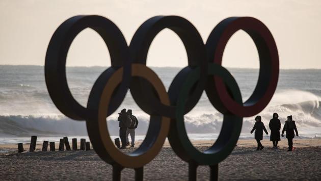 People walk before the Olympic Rings during sunrise on Gyeongpo beach in Gangneung, the host city of the ice venues for the Winter Olympic Games. (Ed Jones / AFP) People walk before the Olympic Rings during sunrise on Gyeongpo beach in Gangneung, the host city of the ice venues for the Winter Olympic Games. (Ed Jones / AFP)