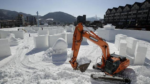 Workers toil on a large ice sculpture at the Pyeongchang Olympic Plaza as preparations continue ahead of the big day. (Charlie Riedel / AP) Workers toil on a large ice sculpture at the Pyeongchang Olympic Plaza as preparations continue ahead of the big day. (Charlie Riedel / AP)