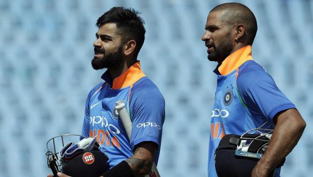 India's captain Virat Kohli (L) with teammate Shikhar Dhawan leave the field after winning their second ODI against South Africa and India at Centurion Park in Pretoria on Sunday. India beat South Africa by 9 wickets.(AP)