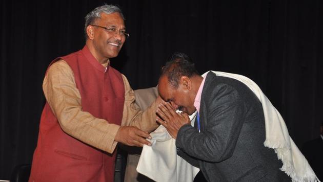Chief minister Trivendra Singh Rawat felicitates a teacher at a workshop on child protection in Dehradun. (HT Photo) Chief minister Trivendra Singh Rawat felicitates a teacher at a workshop on child protection in Dehradun. (HT Photo)