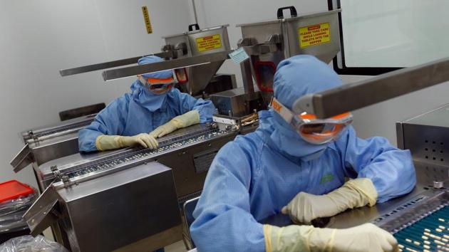Employees inspect tablets as they move along the production line at a pharmaceutical plant of Lupin, India's No. 2 drugmaker, in Verna, in Goa. (REUTERS)