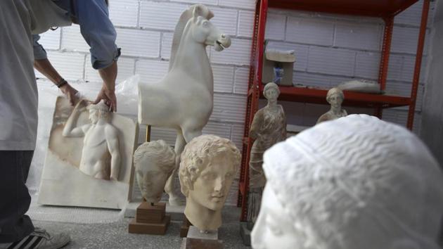 An employee of the Ministry places a copy among other pieces in the warehouse of the Lab in Athens. (Thanassis Stavrakis / AP) An employee of the Ministry places a copy among other pieces in the warehouse of the Lab in Athens. (Thanassis Stavrakis / AP)