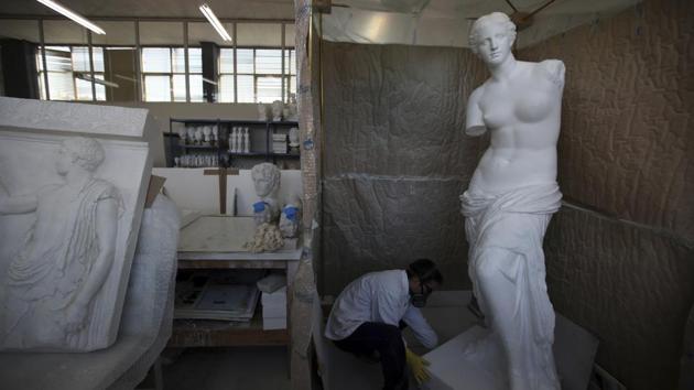 A copy of Venus de Milo, Aphrodite the ancient Greek goddess of love, beauty, pleasure and procreation, goes through colour processing in the Culture Ministry's Lab. The proceeds from the sculptures created here are meant to help fund Greek archaeology and conservation projects. (Thanassis Stavrakis / AP) A copy of Venus de Milo, Aphrodite the ancient Greek goddess of love, beauty, pleasure and procreation, goes through colour processing in the Culture Ministry's Lab. The proceeds from the sculptures created here are meant to help fund Greek archaeology and conservation projects. (Thanassis Stavrakis / AP)