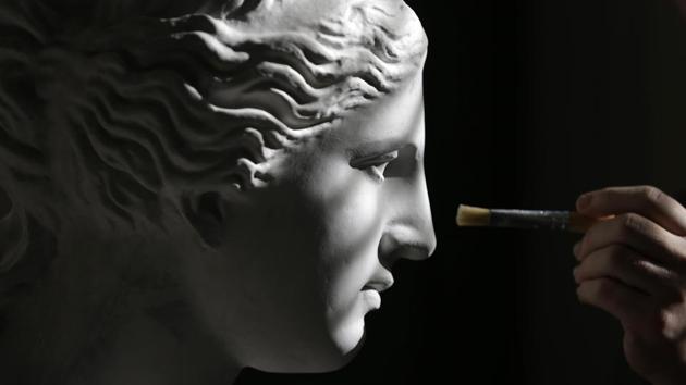 A sculptor paints a copy of the head of Hygeia, deity of health at the Athens’ Culture Ministry Lab. Painstakingly recreating the sculptures of Greece’s ancient masters might be the closest to time travel a sculptor can get. And a group of artists is doing just that at Athens’ Culture Ministry. (Thanassis Stavrakis / AP) A sculptor paints a copy of the head of Hygeia, deity of health at the Athens’ Culture Ministry Lab. Painstakingly recreating the sculptures of Greece’s ancient masters might be the closest to time travel a sculptor can get. And a group of artists is doing just that at Athens’ Culture Ministry. (Thanassis Stavrakis / AP)