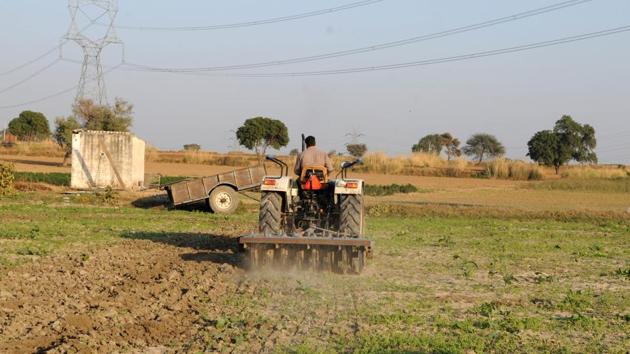 A farmer ploughs fields on a tractor in Sultanpur village. (HT File) A farmer ploughs fields on a tractor in Sultanpur village. (HT File)