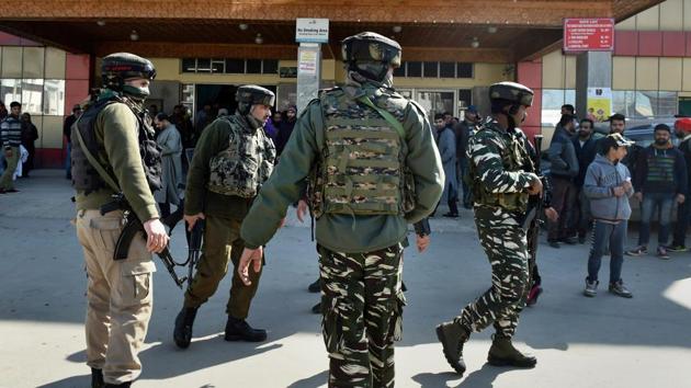 Security personnel stand guard during a search operation after an LeT militant escaped from the police custody with the assailants after Lashkar-e-Taiba militants attacked SMHS hospital, in Srinagar on Tuesday. (PTI Photo) Security personnel stand guard during a search operation after an LeT militant escaped from the police custody with the assailants after Lashkar-e-Taiba militants attacked SMHS hospital, in Srinagar on Tuesday. (PTI Photo)