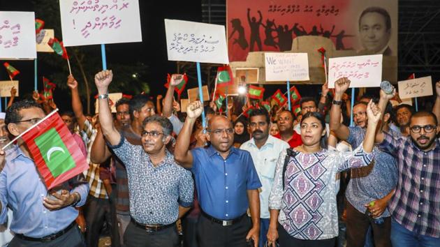 In this Feb.4, 2018 photo, Maldivian opposition supporters shout slogans during a protest as they the urge the government to obey a Supreme Court order to release and retry political prisoners, including an ex-president in Male, Maldives.(AP)