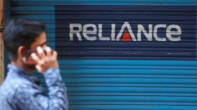 A man speaks on his mobile phone as he walks past a closed shop painted with an advertisement of Reliance Communications in Mumbai, India, January 29, 2018. (REUTERS) A man speaks on his mobile phone as he walks past a closed shop painted with an advertisement of Reliance Communications in Mumbai, India, January 29, 2018. (REUTERS)