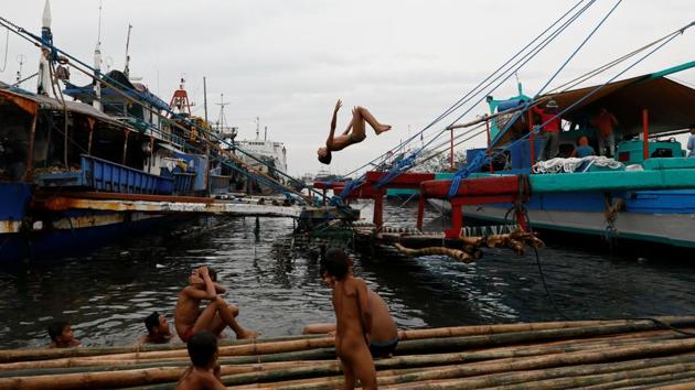 Children swim alongside fishing boats in the polluted waters off Navotas. While her account could not be independently verified, the woman, who asked for anonymity, is certain that police killed her son in cold blood while he was asleep, adding that she even heard them joke about it. (Dondi Tawatao / REUTERS) Children swim alongside fishing boats in the polluted waters off Navotas. While her account could not be independently verified, the woman, who asked for anonymity, is certain that police killed her son in cold blood while he was asleep, adding that she even heard them joke about it. (Dondi Tawatao / REUTERS)