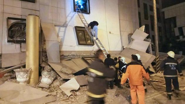 Rescue workers search through rubble outside the Marshal Hotel in Hualien, eastern Taiwan early February 7, 2018, after a strong earthquake struck the island.(AFP)