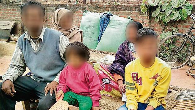 One of the patients (in yellow shirt) who tested positive for HIV, at his residence in Premgunj.(Subhankar Chakraborty/HT Photo)