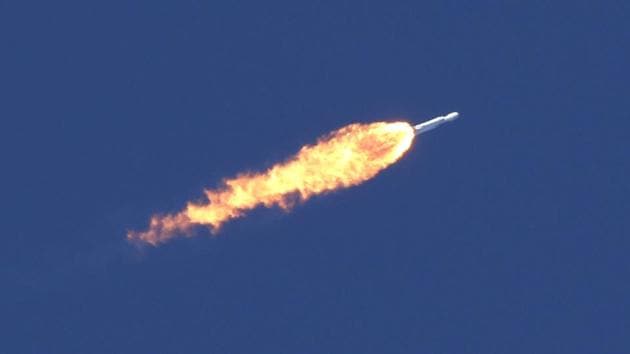 The SpaceX Falcon Heavy rocket trails flames after lift off. Another rocket and spaceship combination being developed by SpaceX, nicknamed BFR -- alternately known as “Big Falcon Rocket” -- could be the vehicle eventually certified for travelers.  (Thom Baur / REUTERS) 
