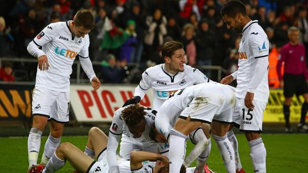 Swansea City's Welsh midfielder Daniel James (on the ground) celebrates with teammates after scoring their eighth goal during the English FA Cup fourth round replay football match between Swansea City and Notts County at The Liberty Stadium in Swansea, south Wales on February 6, 2018. (AFP) Swansea City's Welsh midfielder Daniel James (on the ground) celebrates with teammates after scoring their eighth goal during the English FA Cup fourth round replay football match between Swansea City and Notts County at The Liberty Stadium in Swansea, south Wales on February 6, 2018. (AFP)